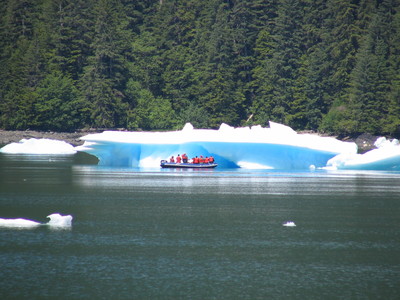 tourists viewing glacier ice from raft